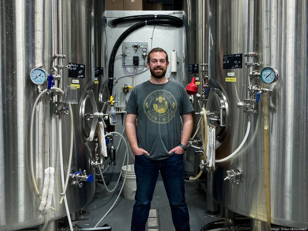 Justin Cox, Founder & CEO of Atlas Brew Pub is photographed in front of distillery
